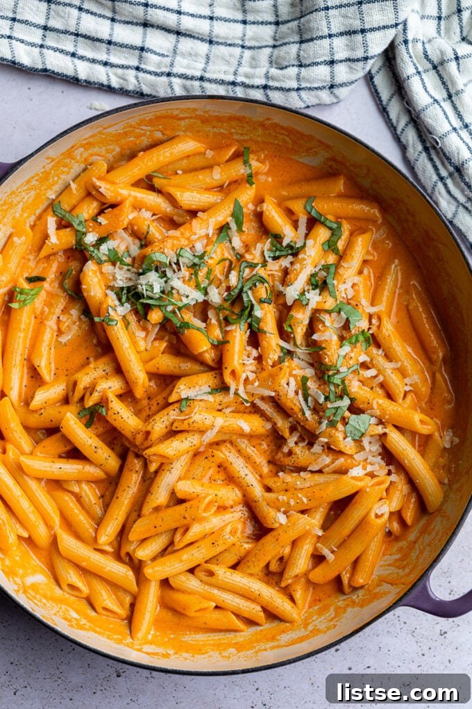 Roasted red pepper pasta served in a large pot, ready for sharing.