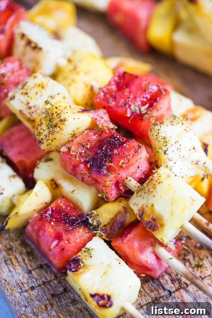 Sizzling Vegetarian Grills 15 A vibrant display of grilled fruit skewers, showcasing beautifully charred and caramelized pieces of fruit on a plate.