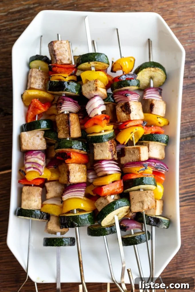 Sizzling Vegetarian Grills 7 A tempting tray filled with savory tofu kebabs interspersed with fresh vegetables, ready for grilling or serving.