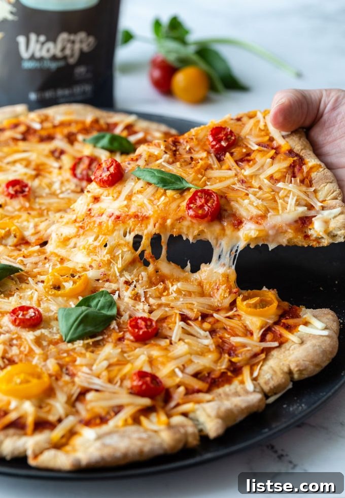 Sizzling Vegetarian Grills 9 A hand reaching for a slice of vegan grilled pizza, topped with vibrant vegetables and melted cheese, fresh off the grill.
