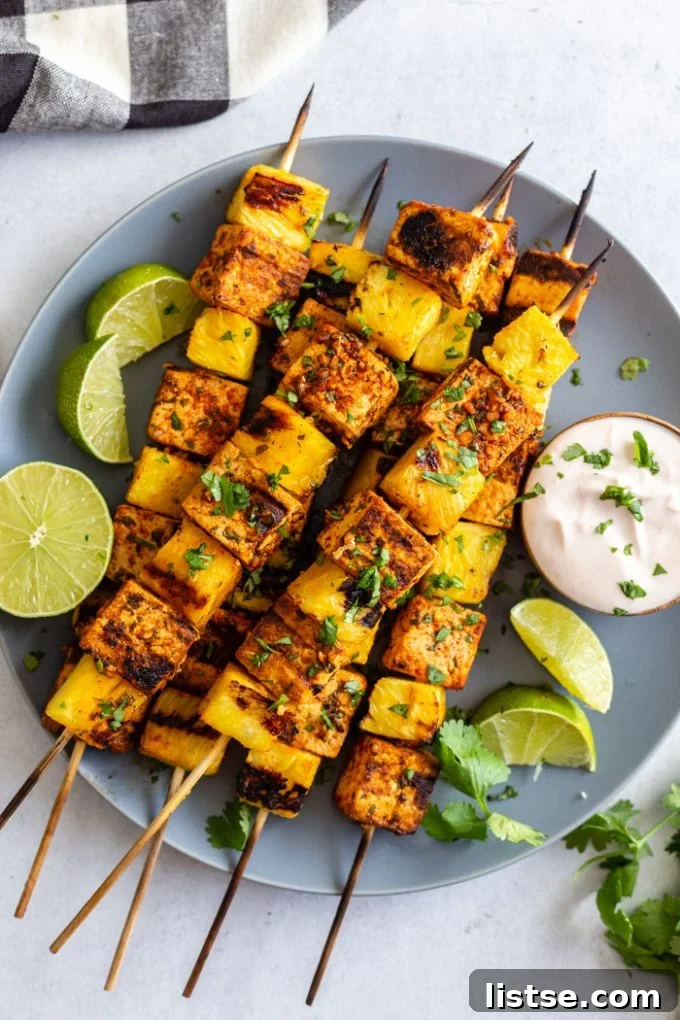 Sizzling Vegetarian Grills 10 Delicious pineapple and tofu skewers arranged artfully on a white plate, ready to be enjoyed.