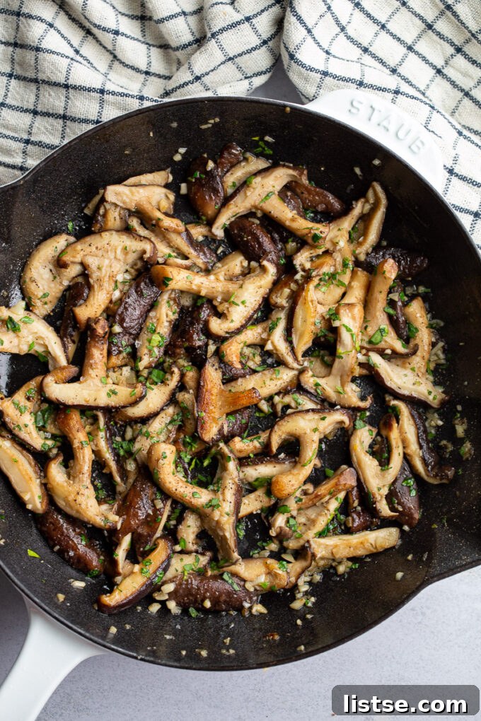Sautéing shiitake mushrooms in a skillet.