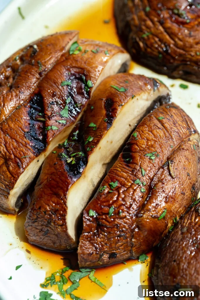 Large portobello mushrooms, expertly sliced and arranged, showcasing their inner texture.