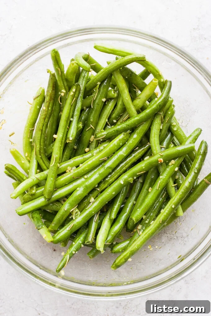 Golden Roasted Potatoes with Tender-Crisp Green Beans 4 Seasoning fresh green beans in a large mixing bowl.