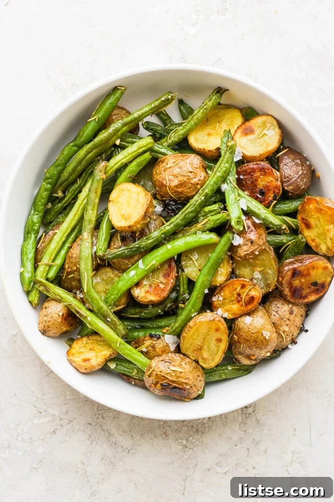 Golden Roasted Potatoes with Tender-Crisp Green Beans 6 Golden-brown roasted potatoes and crisp green beans served in a white bowl.