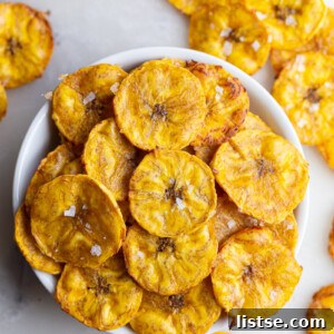 Plantain chips served in a small white bowl, illustrating the final dish.