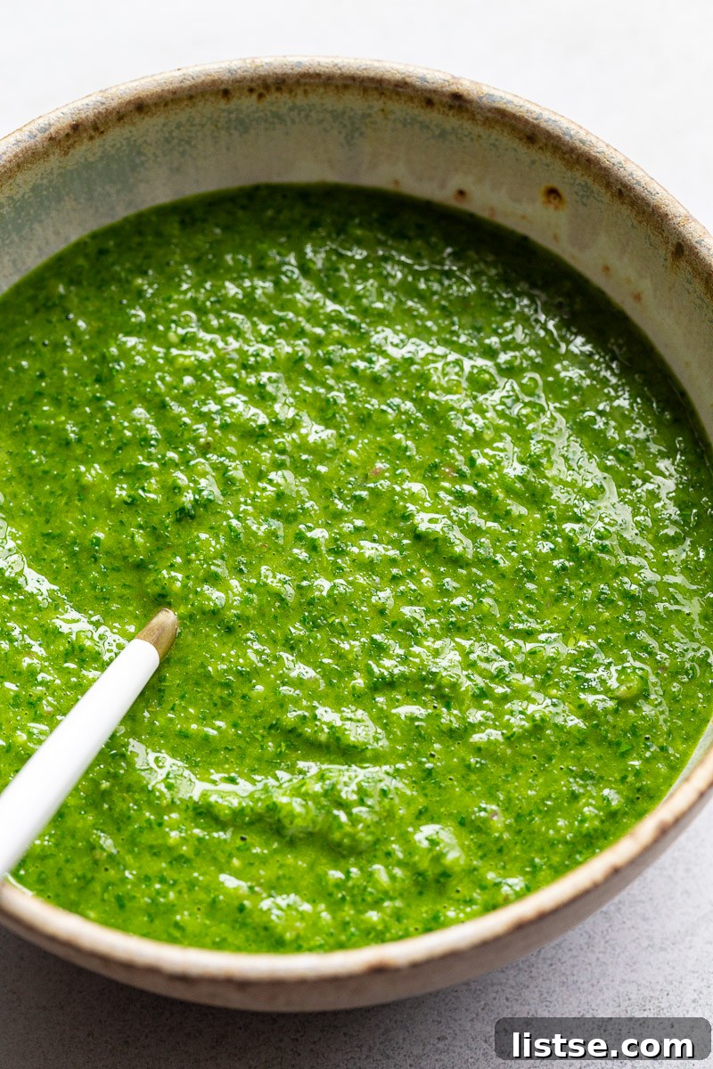 Zesty Argentine Chimichurri 3 Vibrant homemade chimichurri sauce in a stylish green bowl, showcasing its rich texture.