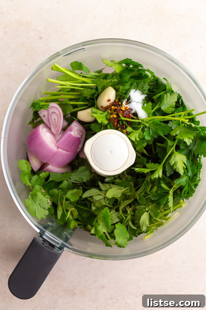 Zesty Argentine Chimichurri 5 Fresh herbs, shallot, and garlic placed in a food processor, ready for blending.
