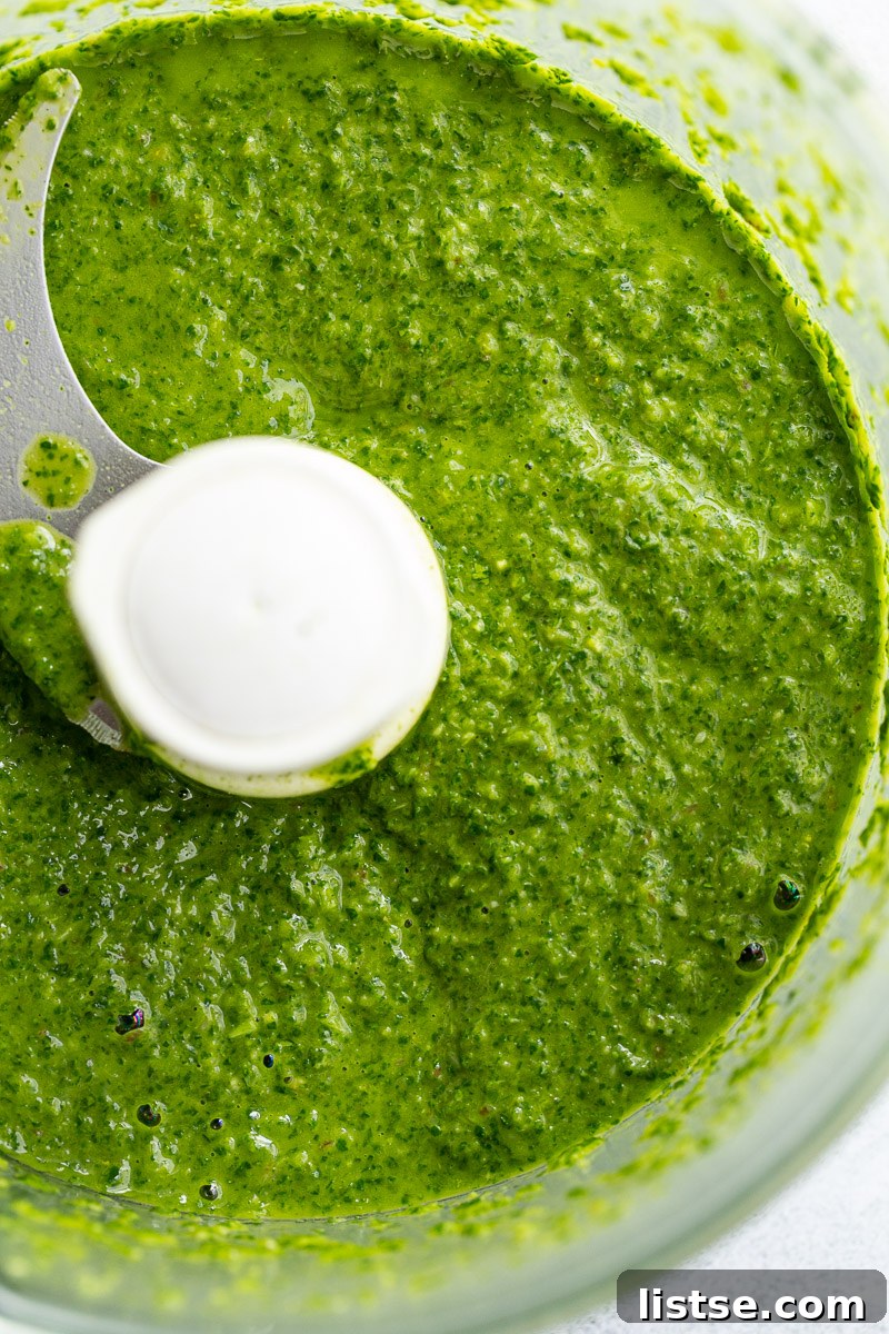 Zesty Argentine Chimichurri 8 A food processor bowl filled with finely chopped green herbs, ready to become chimichurri sauce.