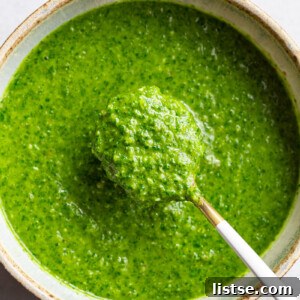 Close-up of Chimichurri sauce being served with a spoon.