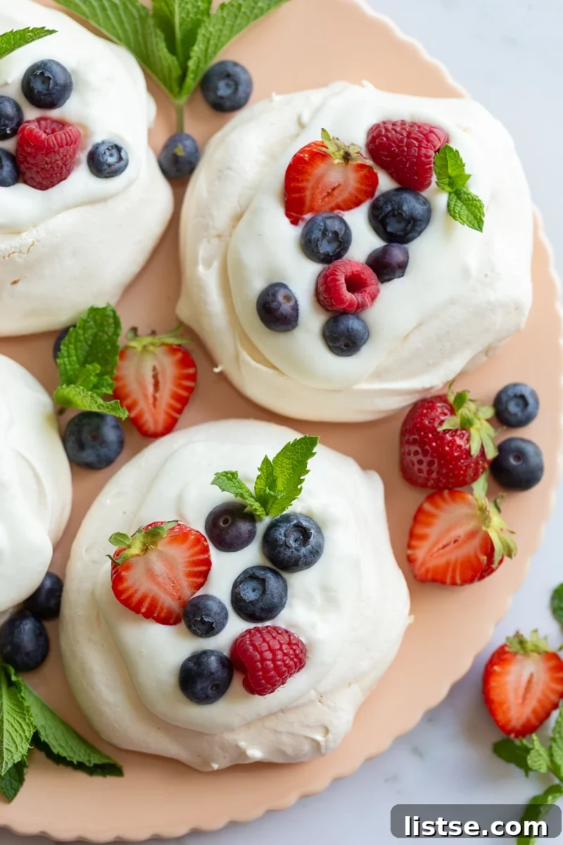 Beautiful Pavlova dessert topped with whipped cream and fresh berries