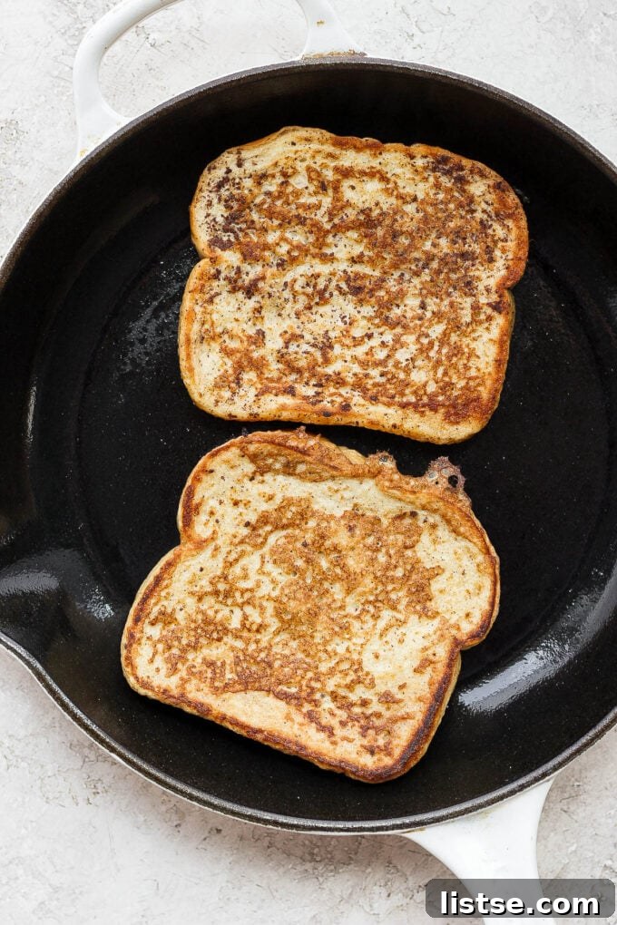 Cooking slices of bread on a skillet.
