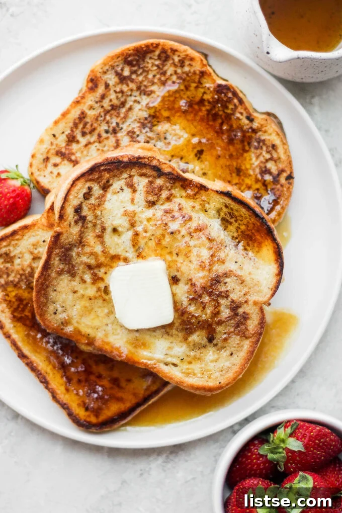 Slices of French toast on a white plate.