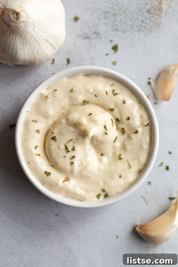 Golden Roasted Garlic Aioli 4 Aioli sauce garnished with black pepper.