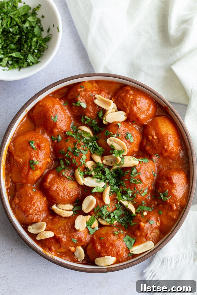 A vibrant bowl of Dum Aloo, garnished with fresh cilantro, ready to be served.
