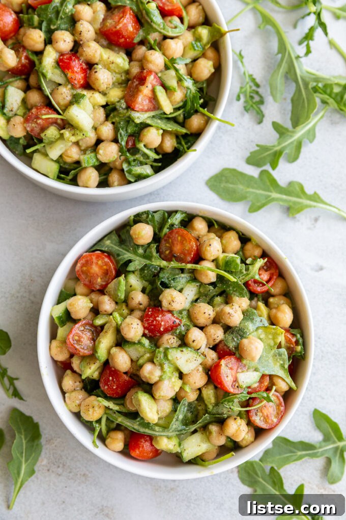 A vibrant and fresh Chickpea Avocado Salad served in a small white bowl, ready to eat.