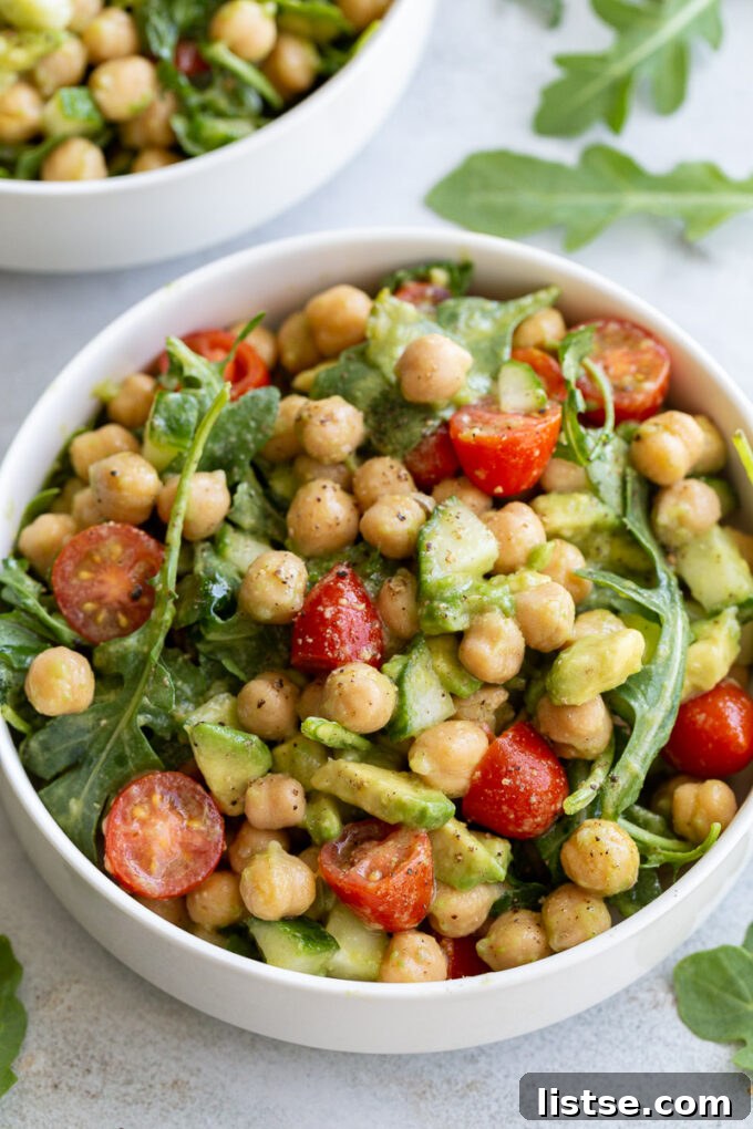 Freshly prepared Chickpea Avocado Salad in a white bowl, showing the vibrant colors of the ingredients.