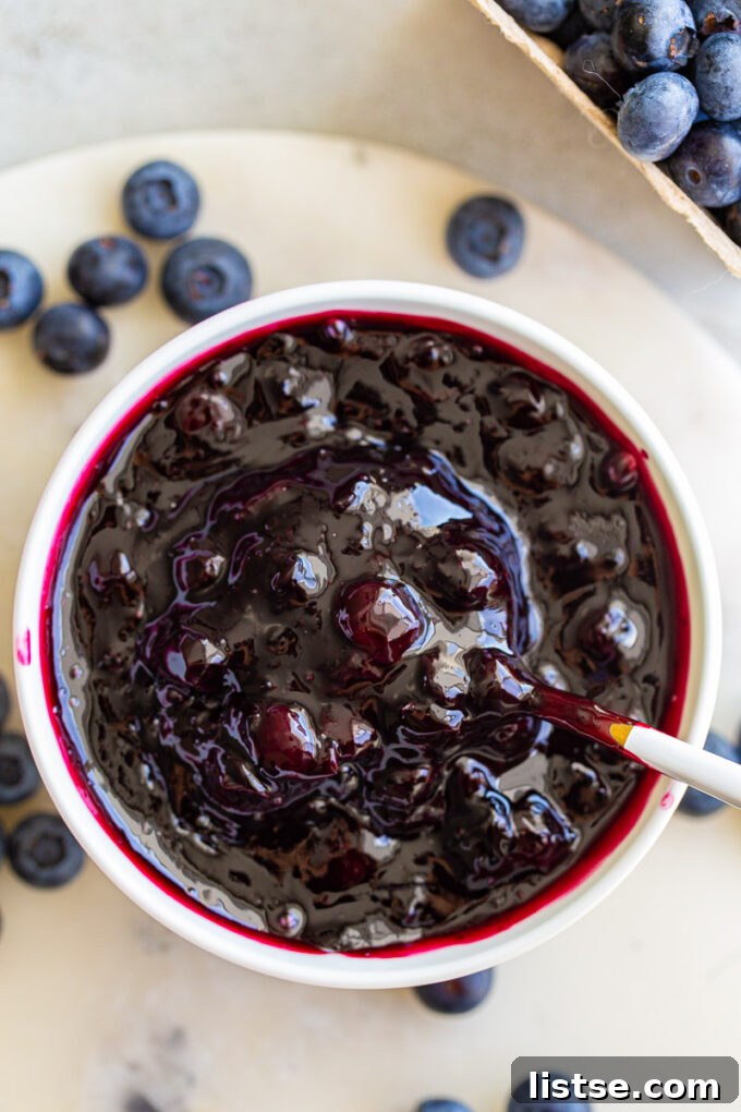 Sweet Blueberry Nectar 3 A large white bowl filled with glistening blueberry compote, ready to be spooned out.