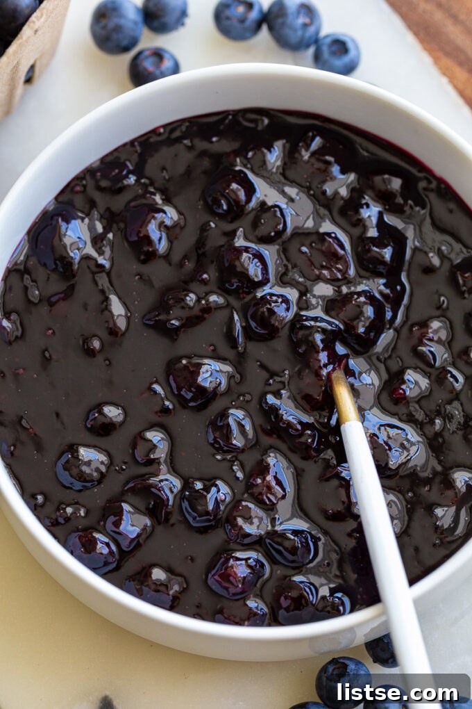 Sweet Blueberry Nectar 5 A close-up of a spoonful of vibrant blueberry sauce, showcasing its rich color and inviting texture.