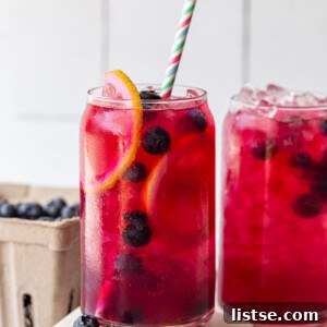 Blueberry lemonade served with a straw.