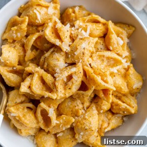creamy pumpkin macaroni pasta with shredded parmesan on top