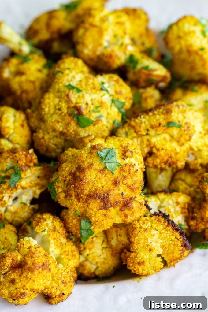Roasted cauliflower garnished with fresh cilantro and a lemon wedge.
