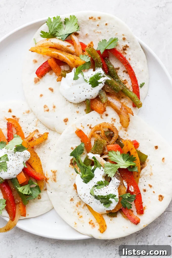 Fajitas made with flour tortillas, veggies, sour cream and cilantro.