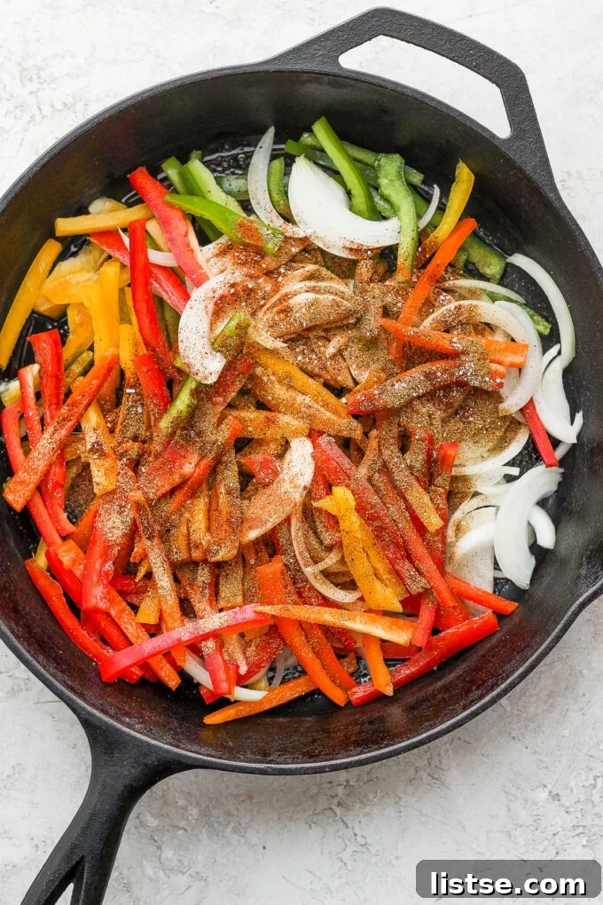 Adding vegetables and spices to a skillet.