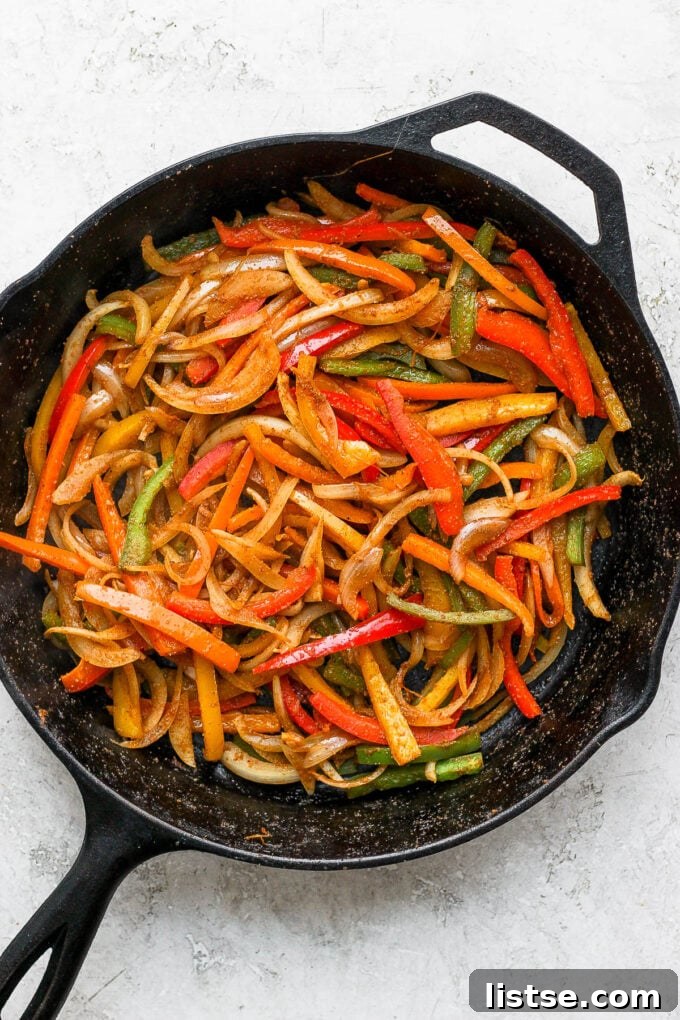 Sautéed bell peppers and onion in a cast iron skillet.