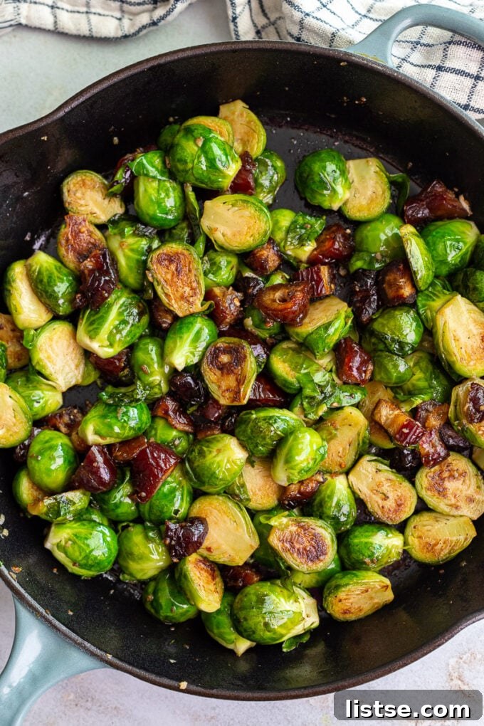 A serving of Date Sweetened Brussels Sprouts, showcasing the beautiful combination of green sprouts and golden-brown dates.