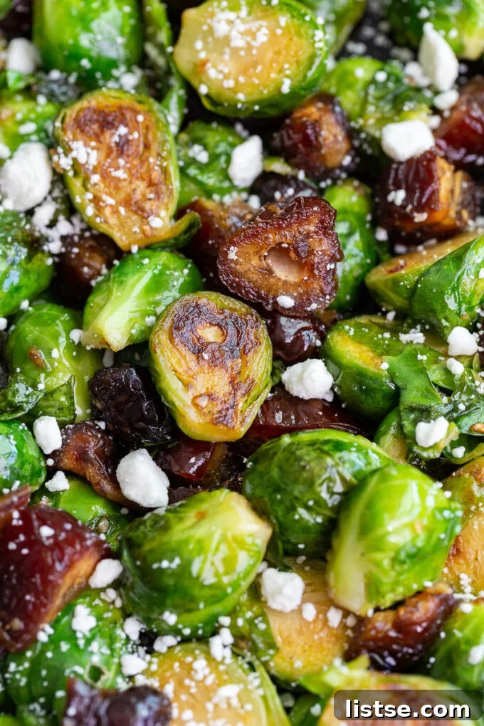 A close-up of a skillet filled with Date Sweetened Brussels Sprouts, glistening with caramelized dates and spices.