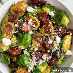 Close-up of golden-brown Date Sweetened Brussels Sprouts in a pan, with chopped dates and hints of garlic visible.