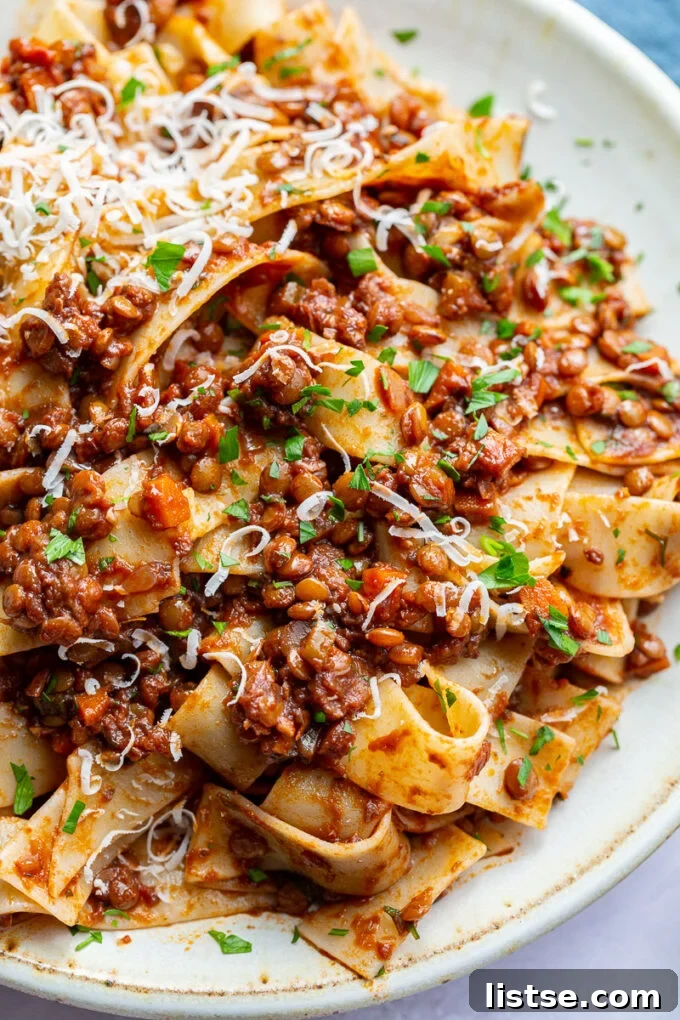 Hearty Lentil Bolognese 3 Saucy lentil bolognese pasta garnished with vibrant fresh parsley, ready to be enjoyed.