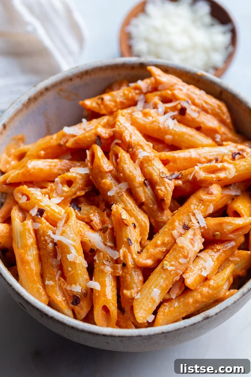Penne pasta served with rose sauce in a small bowl.