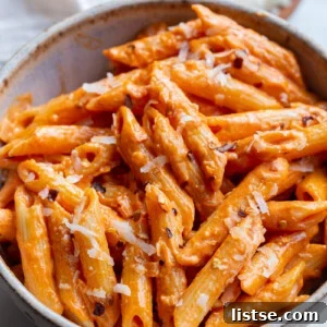 Penne pasta served with rose sauce in a small bowl.