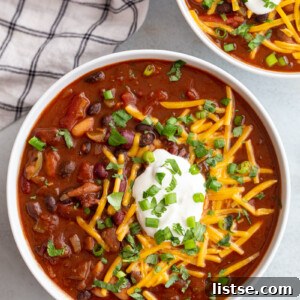 Ultimate Instant Pot Chili 7 Instant pot chili topped with shredded cheese, sour cream and green onions.