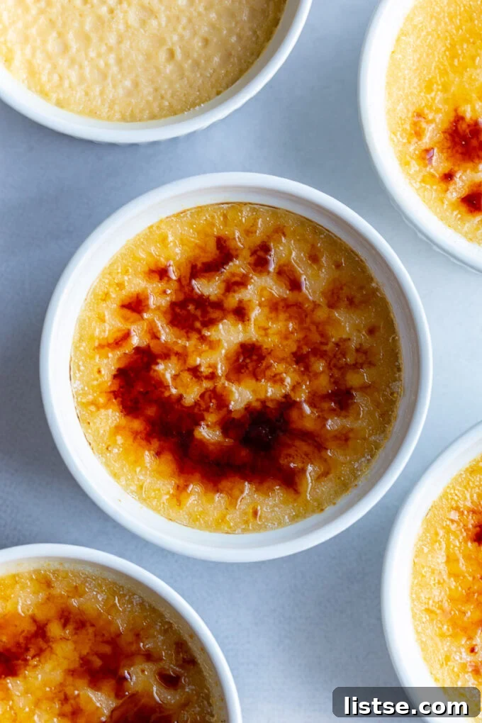 Crème Brûlée served in a pristine white ramekin, ready to be enjoyed.
