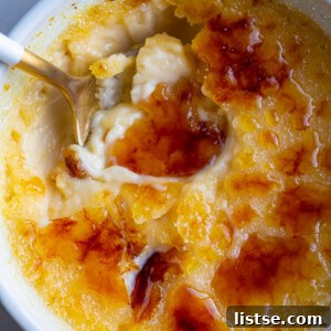 A spoon in a small bowl with Crème Brûlée.