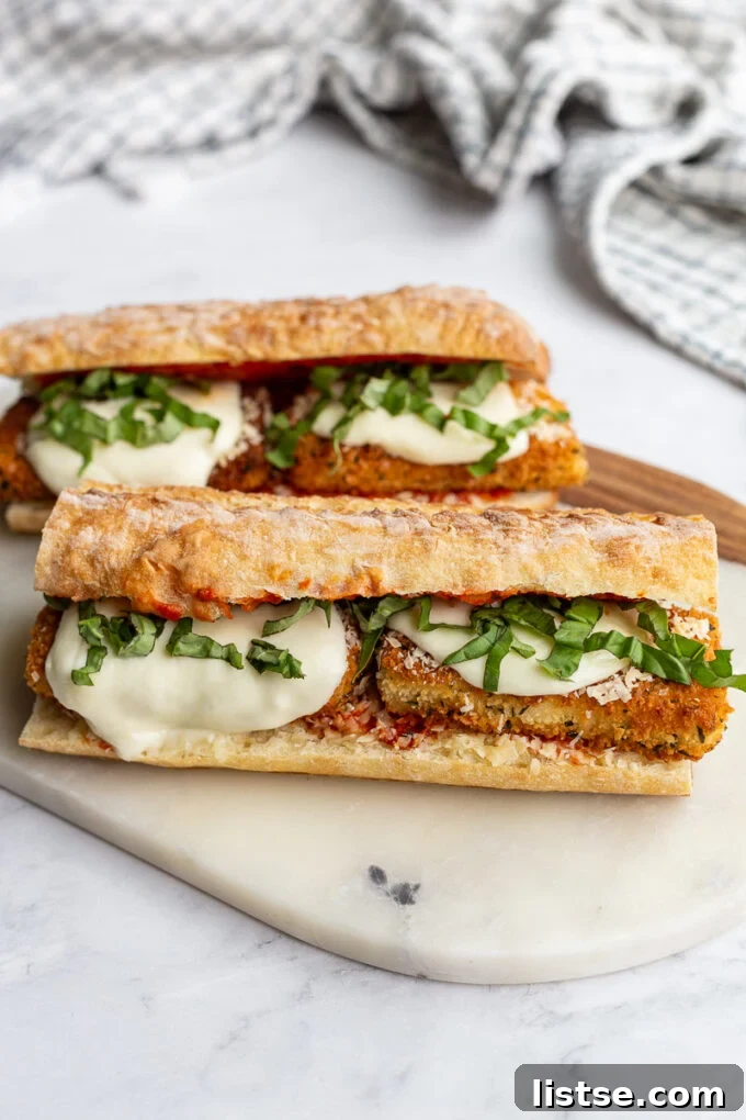 Tofu Parmesan Sandwiches on a marble cutting board.