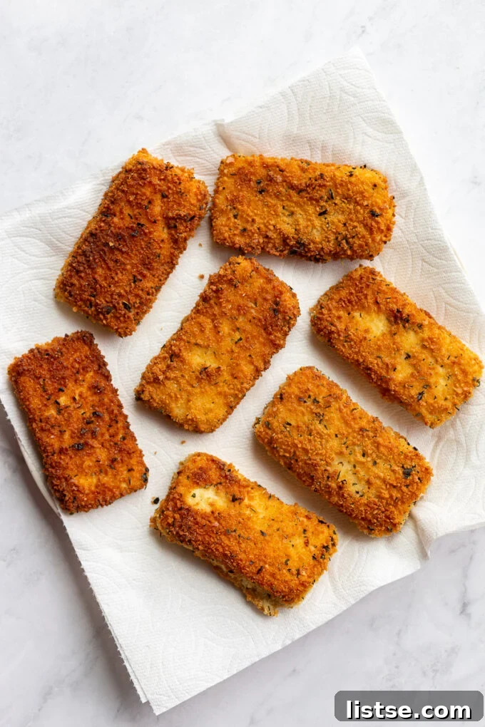 Breaded and fried tofu pieces on paper towels.