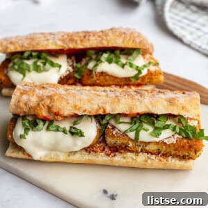 Tofu Parmesan Sandwiches on a marble cutting board.