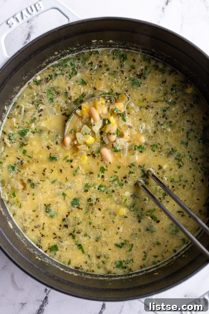 Stirring a pot of white chickpea chili.