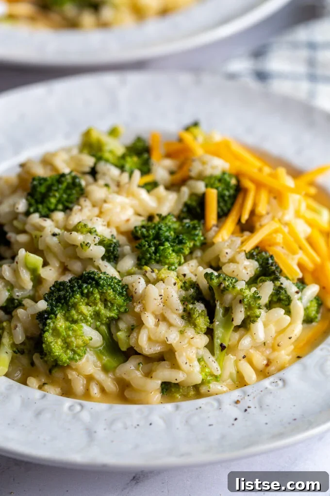 Creamy Broccoli Cheese Risotto 6 Close-up of a creamy Broccoli and Cheese Risotto in a white bowl, ready to be eaten.