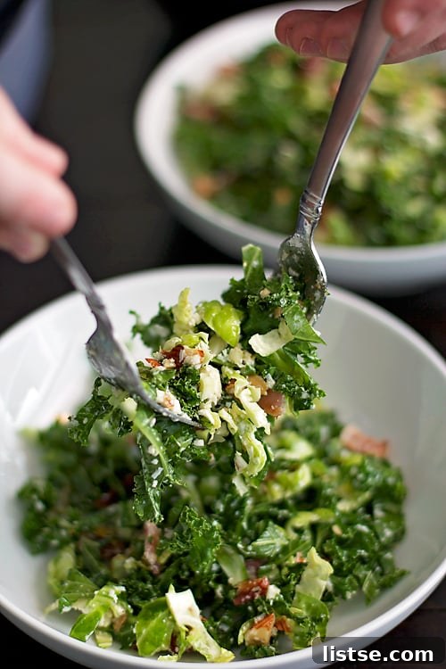 Close-up of fresh Kale and Brussels Sprout Salad with almonds and bacon