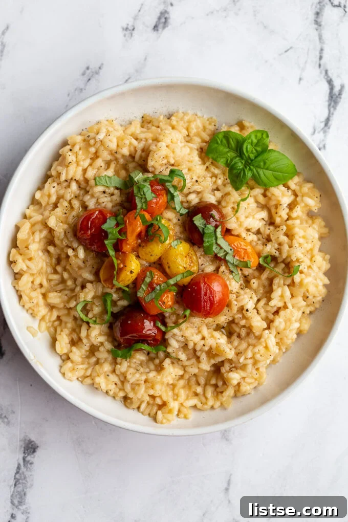 Crafting Perfect Risotto 6 Risotto topped with vibrant cherry tomatoes and fresh basil leaves.