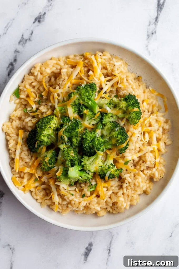 Crafting Perfect Risotto 8 A bowl of creamy risotto served with steamed broccoli florets on top.