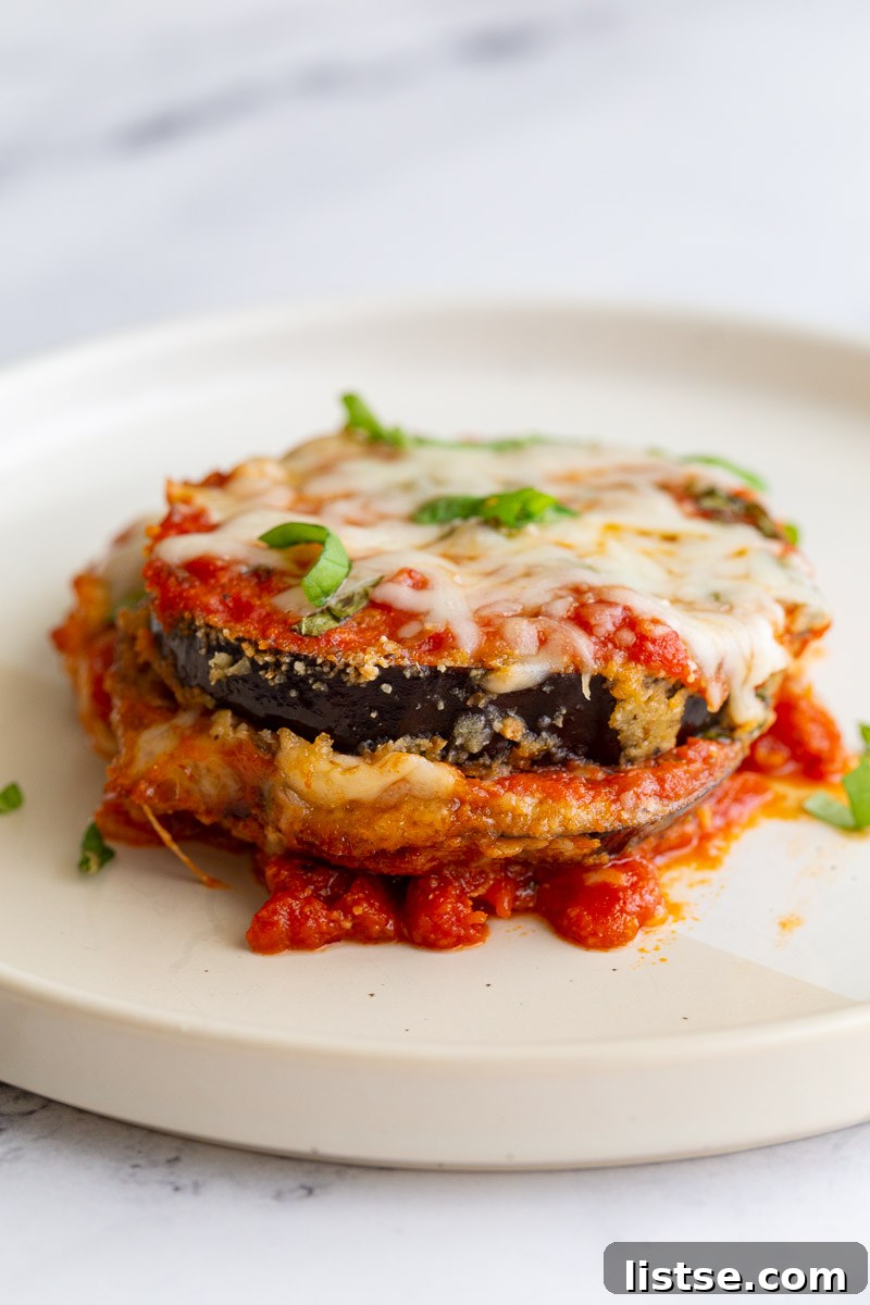 Hearty Eggplant Parmesan Bake 3 Slice of eggplant parmesan on a white plate.