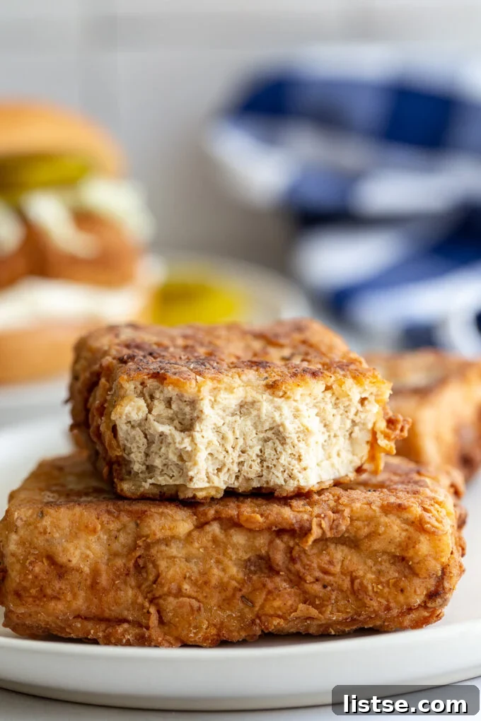 Southern Fried Tofu Sandwich 6 Tofu 'chicken' fillets, one cut in half to showcase the porous, meaty texture achieved through freezing.