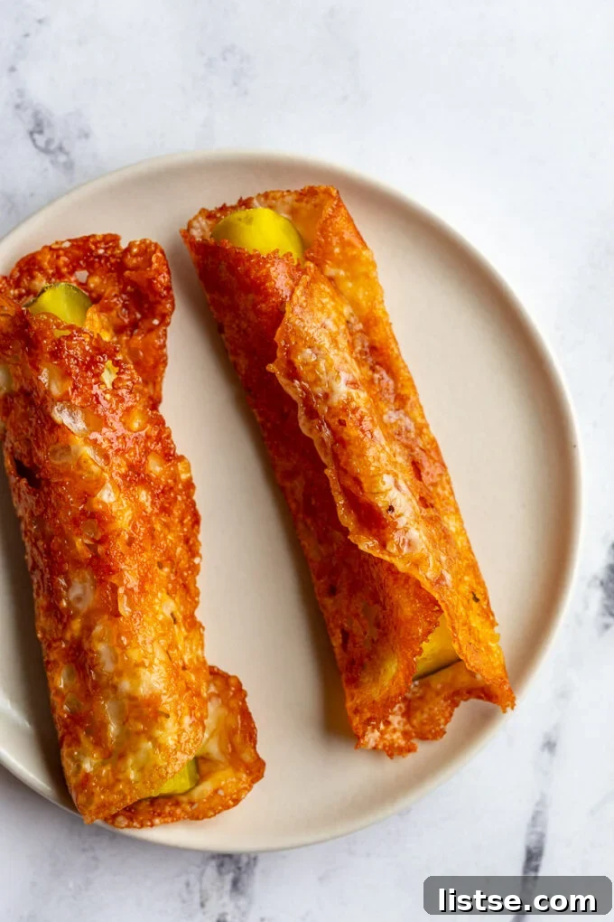 Pickle in a blanket: pickle spear wrapped in crispy cheese, showcasing its golden-brown texture