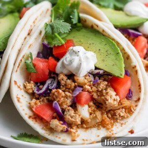 Zesty Quinoa Tofu Taco Crumbles 7 A delicious vegan taco filled with quinoa and tofu taco meat, garnished with fresh vegetables.